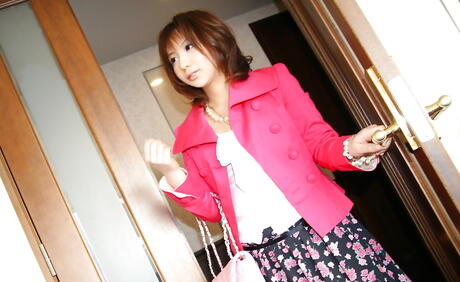 Curious japanese cutie Asako posing in fancy skirt on camera outside